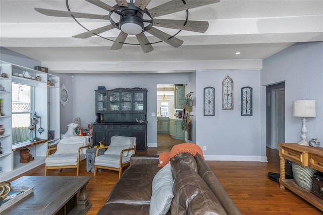 living room with baseboards, wood finished floors, and ceiling fan