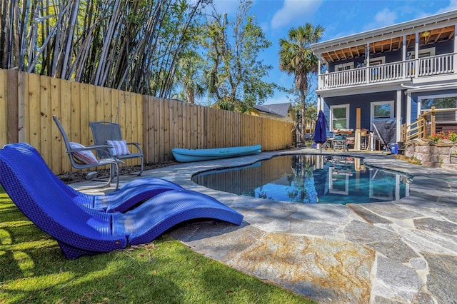 view of swimming pool featuring a patio, a fenced backyard, and a fenced in pool