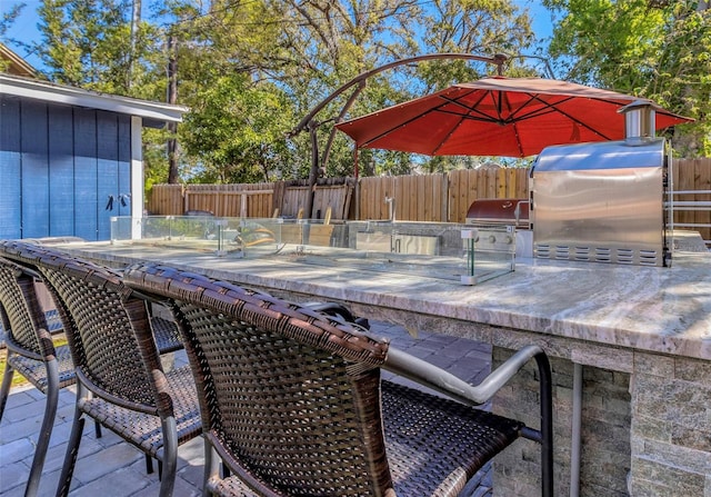 deck with a patio area, area for grilling, and fence