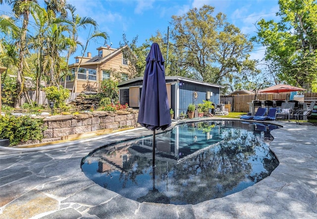 view of swimming pool with a patio area, a fenced in pool, and fence