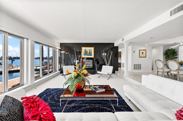 520 Belle Isle Ave, Belleair Beach, FL 33786 - living area featuring visible vents, a water view, and decorative columns