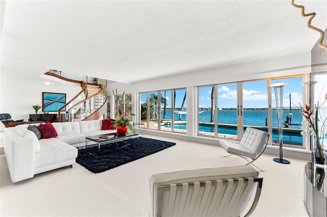 520 Belle Isle Ave, Belleair Beach, FL 33786 - living area featuring stairs, a water view, and carpet floors