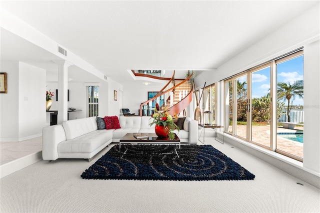 520 Belle Isle Ave, Belleair Beach, FL 33786 - carpeted living room with stairs, baseboards, and visible vents