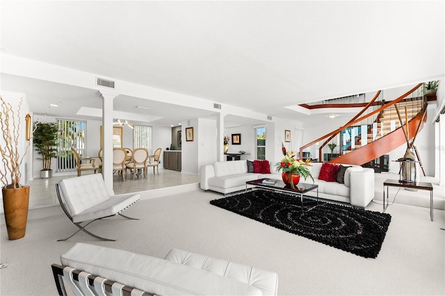 520 Belle Isle Ave, Belleair Beach, FL 33786 - living room featuring stairs, visible vents, ornate columns, and carpet floors