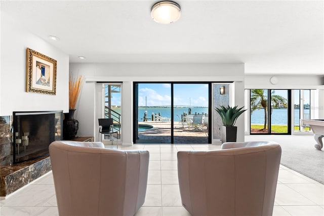 520 Belle Isle Ave, Belleair Beach, FL 33786 - living room featuring recessed lighting, light colored carpet, a water view, and a high end fireplace
