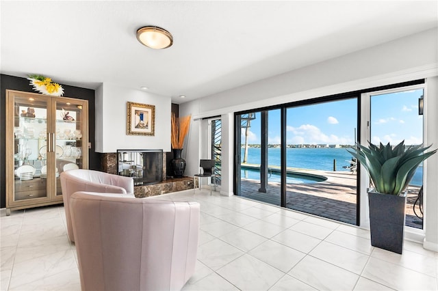 520 Belle Isle Ave, Belleair Beach, FL 33786 - living area with a multi sided fireplace, marble finish floor, and a water view
