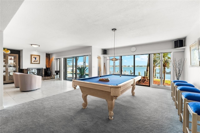 520 Belle Isle Ave, Belleair Beach, FL 33786 - rec room featuring a textured ceiling, billiards, a water view, and carpet floors