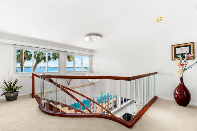 520 Belle Isle Ave, Belleair Beach, FL 33786 - stairs featuring carpet, baseboards, and a chandelier