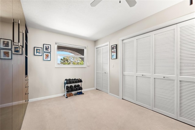 520 Belle Isle Ave, Belleair Beach, FL 33786 - interior space with baseboards, a textured ceiling, a ceiling fan, and carpet