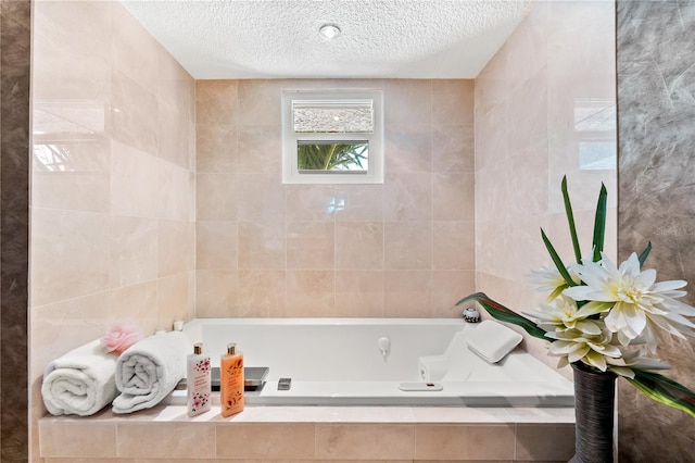 520 Belle Isle Ave, Belleair Beach, FL 33786 - full bathroom with a textured ceiling, tile walls, and a tub with jets