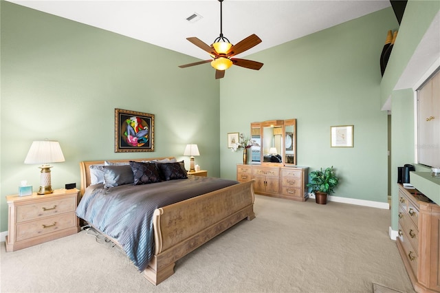 520 Belle Isle Ave, Belleair Beach, FL 33786 - bedroom with visible vents, a ceiling fan, a high ceiling, baseboards, and light colored carpet