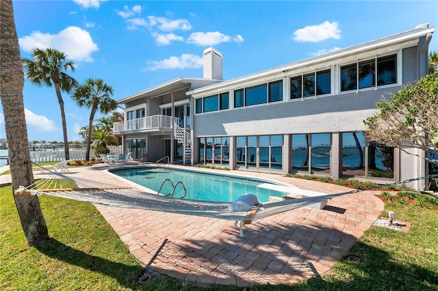 520 Belle Isle Ave, Belleair Beach, FL 33786 - outdoor pool with a diving board, fence, stairs, and a patio area