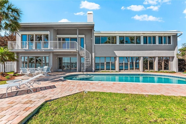 520 Belle Isle Ave, Belleair Beach, FL 33786 - rear view of property featuring stairway, stucco siding, a chimney, an outdoor pool, and a patio