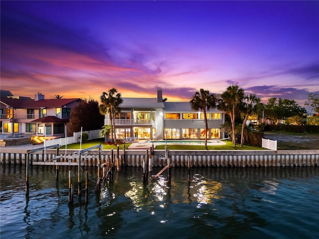 520 Belle Isle Ave, Belleair Beach, FL 33786 - rear view of house with a chimney, fence, a balcony, and a water view