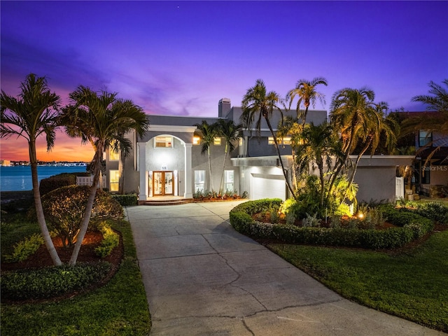 520 Belle Isle Ave, Belleair Beach, FL 33786 - view of front of home with concrete driveway, french doors, and stucco siding