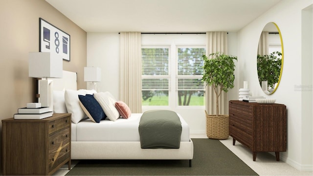 bedroom featuring light colored carpet and baseboards