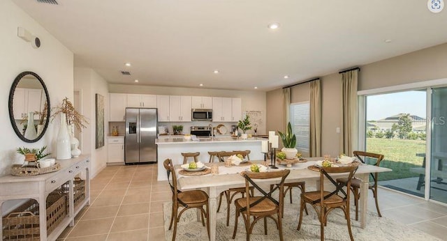 dining area featuring light tile patterned floors, recessed lighting, and visible vents