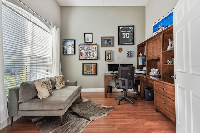 office featuring baseboards and light wood finished floors