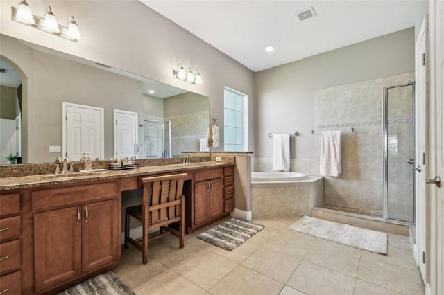 bathroom featuring tile patterned floors, visible vents, a shower stall, double vanity, and a bath