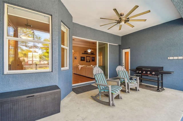 view of patio with a grill and a ceiling fan