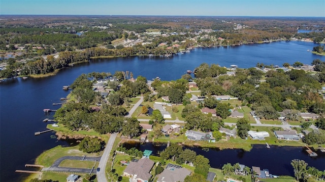 birds eye view of property featuring a residential view, a wooded view, and a water view