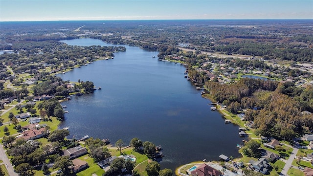 aerial view featuring a forest view and a water view