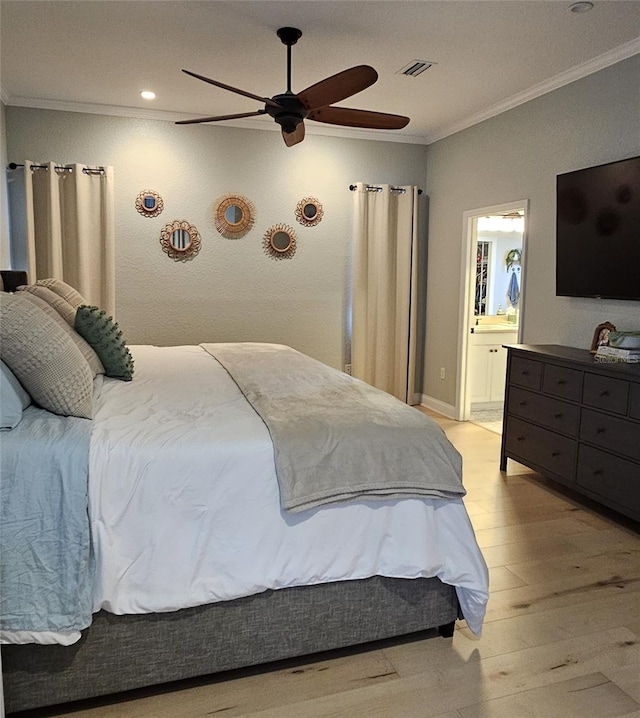 bedroom featuring visible vents, a ceiling fan, crown molding, and light wood-style floors