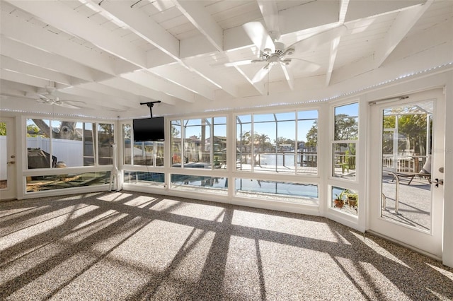 unfurnished sunroom featuring ceiling fan