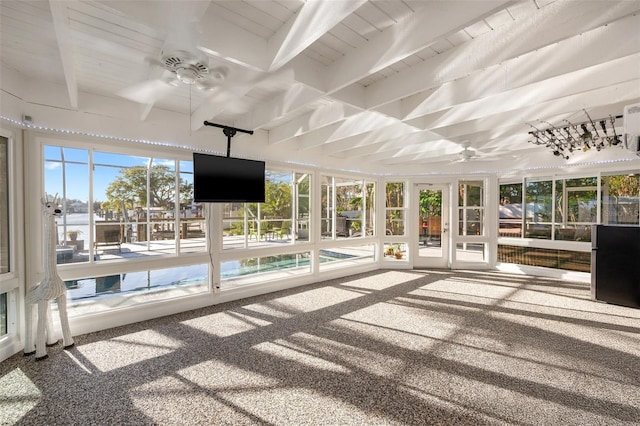 unfurnished sunroom with beam ceiling, wood ceiling, and a ceiling fan