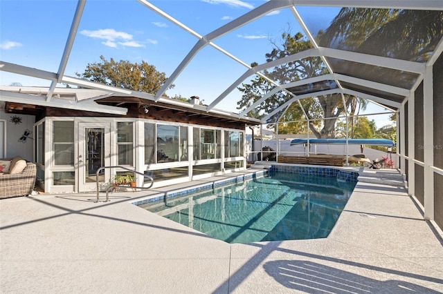 view of pool featuring glass enclosure, a patio, and a fenced in pool