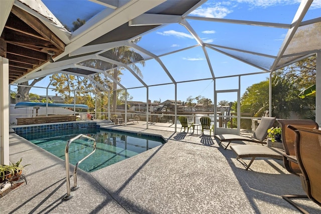 outdoor pool with a lanai and a patio area