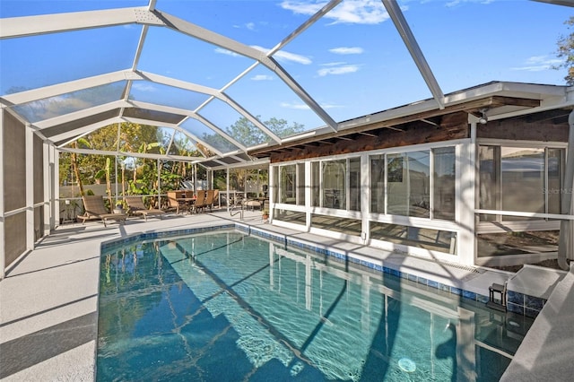 view of swimming pool with a lanai, outdoor dining space, and a patio area