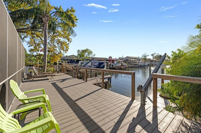 dock area with glass enclosure and a water view