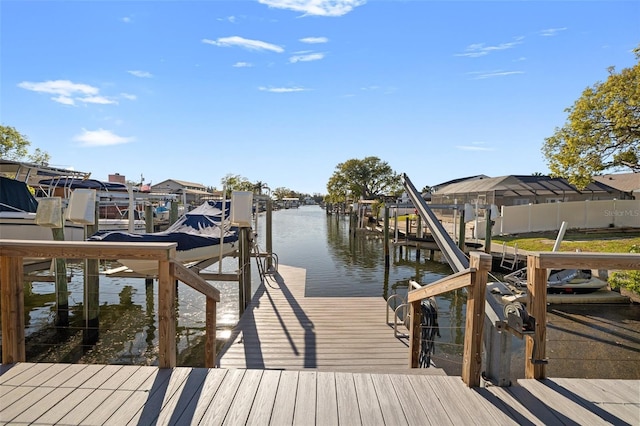 dock area featuring boat lift and a water view