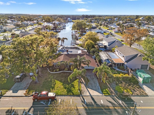 drone / aerial view featuring a residential view and a water view