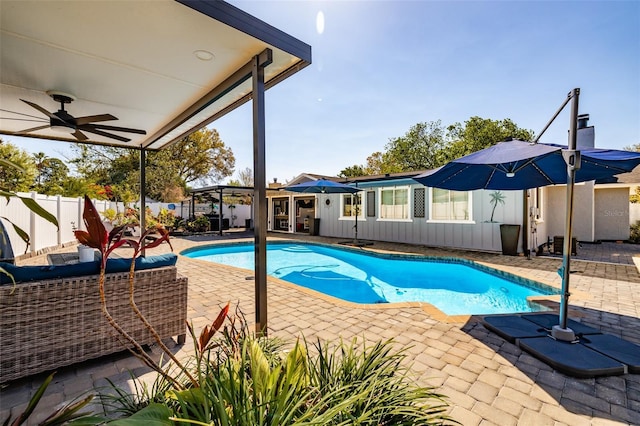 view of pool featuring a fenced in pool, a patio, fence private yard, and a ceiling fan