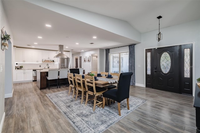 dining area with vaulted ceiling, recessed lighting, wood finished floors, and baseboards