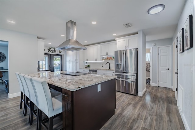 kitchen featuring visible vents, a sink, a center island, appliances with stainless steel finishes, and island range hood