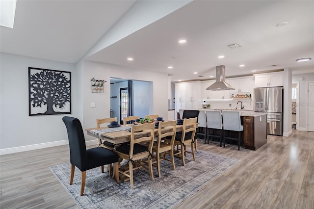 dining space featuring light wood finished floors, visible vents, recessed lighting, and baseboards