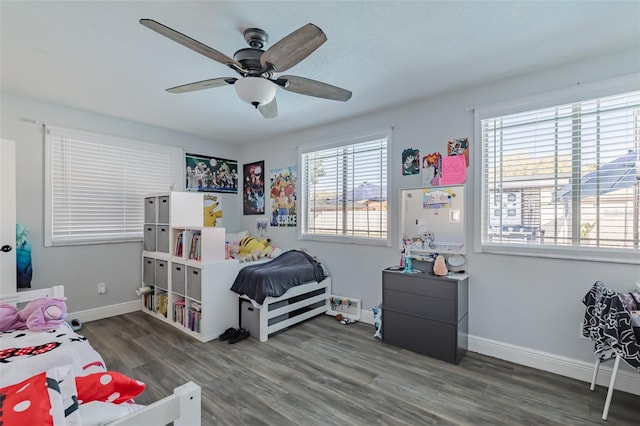 bedroom featuring a ceiling fan, wood finished floors, and baseboards