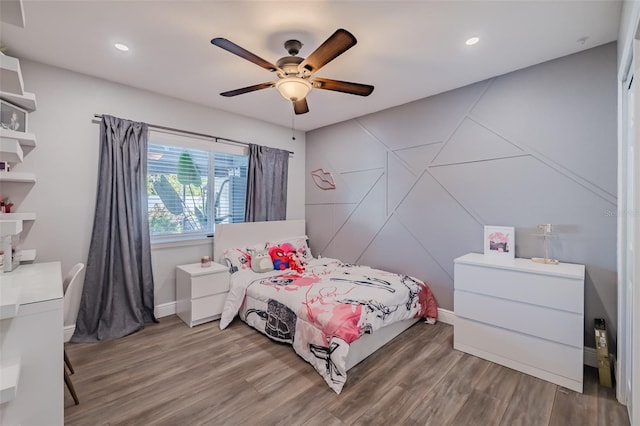 bedroom with recessed lighting, wood finished floors, baseboards, and ceiling fan