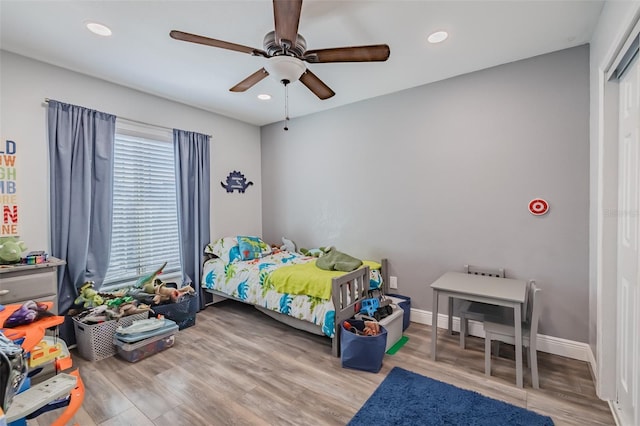 bedroom with recessed lighting, ceiling fan, baseboards, and wood finished floors