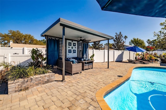 view of pool with a patio, a fenced backyard, a fenced in pool, an outdoor hangout area, and ceiling fan