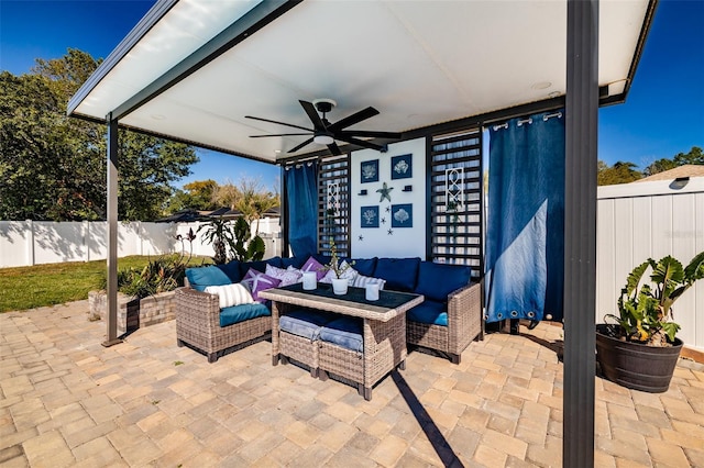 view of patio with an outdoor living space, a ceiling fan, and a fenced backyard