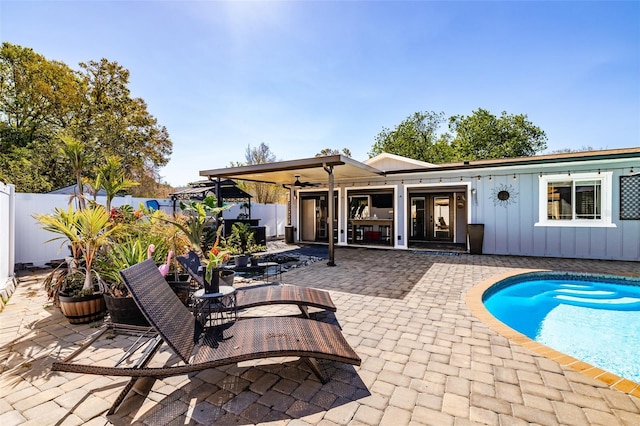 pool with a patio area, outdoor dining space, and a fenced backyard