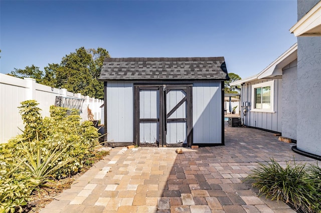 view of shed with fence