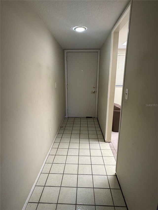 3046 Eastland Blvd Unit J106, Clearwater, FL 33761 - hall with a textured ceiling and light tile patterned floors