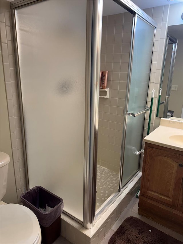 3046 Eastland Blvd Unit J106, Clearwater, FL 33761 - bathroom with a stall shower, toilet, and vanity
