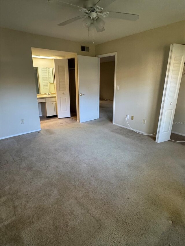 3046 Eastland Blvd Unit J106, Clearwater, FL 33761 - unfurnished bedroom with light colored carpet, baseboards, and a ceiling fan