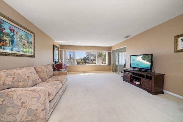 carpeted living room with visible vents and baseboards